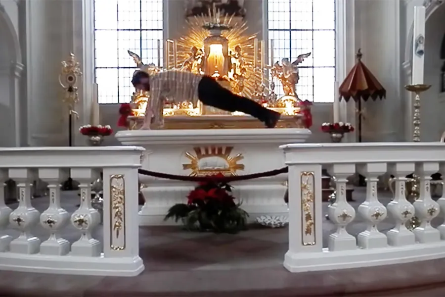 Screenshot of the artist doing pushups on the altar. ?w=200&h=150