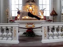 Screenshot of the artist doing pushups on the altar. 