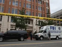 Local and federal investigators work to gather evidence after a security guard was shot in the arm at the Family Research Council offices Aug. 15, 2012 in Washington, DC. 