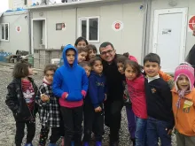 Seminarian Roni Marzina Momica with a group of children outside an Aid to the Church in Need office. Photo Courtesy of Roni Marzina Momica.