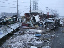 Snow-covered wreckage in Sendai City, Japan. 