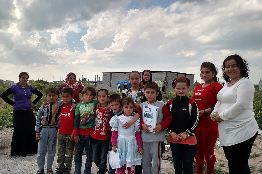 Shelan Jibrael (far right) stands with a group of refugees in Erbil, Iraq. ?w=200&h=150