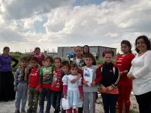 Shelan Jibrael (far right) stands with a group of refugees in Erbil, Iraq. 