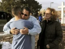 Ruben Allen hugs his son Alex Allen, 17, after a school shooting on Dec. 13, 2013 at Arapahoe High School in Centennial, CO. Mother JoAnne Allen is right. 
