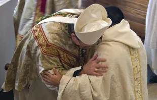 A bishop and a priest exchange the sign of peace during Mass. Credit: Father Lawrence Lew, OP; photo courtesy of Martin Beek via Flickr (CC BY-NC-ND 2.0)