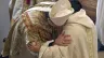 A bishop and a priest exchange the sign of peace during Mass.