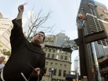 Fr. Brian Jordan stands in front of the World Trade Center cross. 