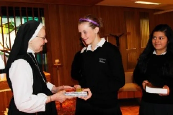 Sister Jane de Chantal Smisek presents a Bible to Visitation freshman Colleen Scallen Credit Christina Capecchi for The Catholic Spirit CNA US Catholic News 10 19 12