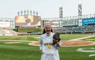 Sister Mary Jo Sobiek, OP, prepares to throw the first pitch at a Chicago White Sox game.   Iron & Honey Photography