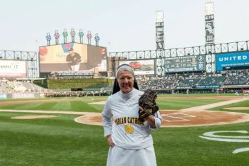 Sister Mary Jo Sobiek OP prepares to throw the first pitch at a Chicago White Sox game Credit Iron and Honey Photography