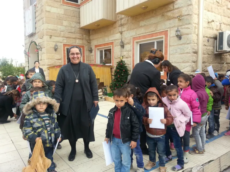 Sister Sanaa Hana, who was forced from her convent in Mosul by the Islamic State, is seen in Erbil with children in front of a house where she has found refuge. ?w=200&h=150