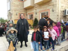 Sister Sanaa Hana, who was forced from her convent in Mosul by the Islamic State, is seen in Erbil with children in front of a house where she has found refuge. 