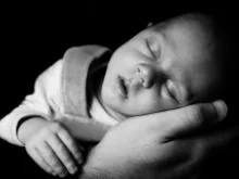 Sleeping Baby On A Hand by Vera Kratochvil (CC0 1.0).