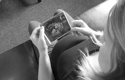 A woman looks at a sonogram image of her unborn baby. ?w=200&h=150