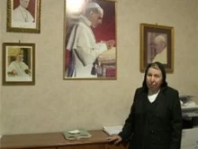 Sr. Marchione poses in front of her recently framed picture of Pope Pius XII