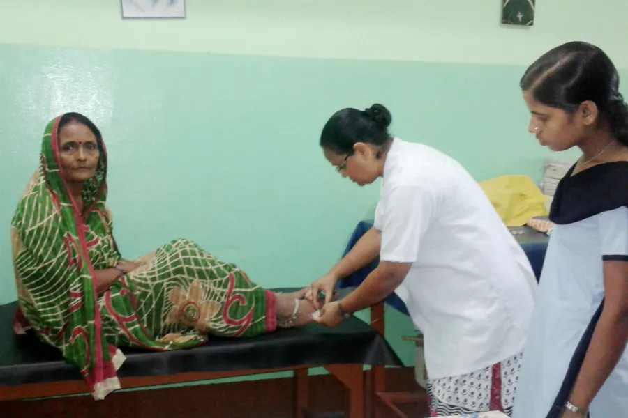 Sister Philomena Guria, RNDM, treats a snake bite patient. Photo courtesy of the Sisters of Our Lady of Missions.?w=200&h=150