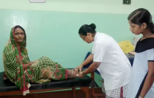 Sister Philomena Guria, RNDM, treats a snake bite patient. Photo courtesy of the Sisters of Our Lady of Missions. 