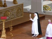 Sr. Simon-Pierre, who was cured of Parkinson's disease through Bl. John Paul's intercession, carries a relic of his blood during the beatification ceremony