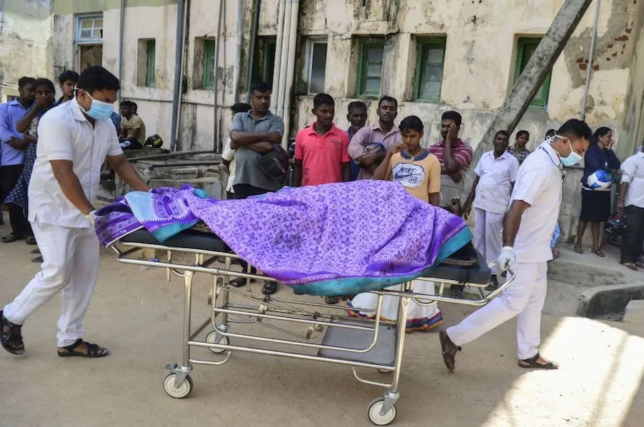 Sri Lankan hospital workers transport a body to a hospital morgue after several bomb blasts on Easter Sunday. ?w=200&h=150