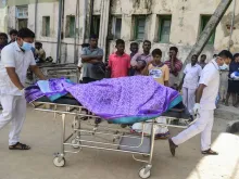 Sri Lankan hospital workers transport a body to a hospital morgue after several bomb blasts on Easter Sunday. 