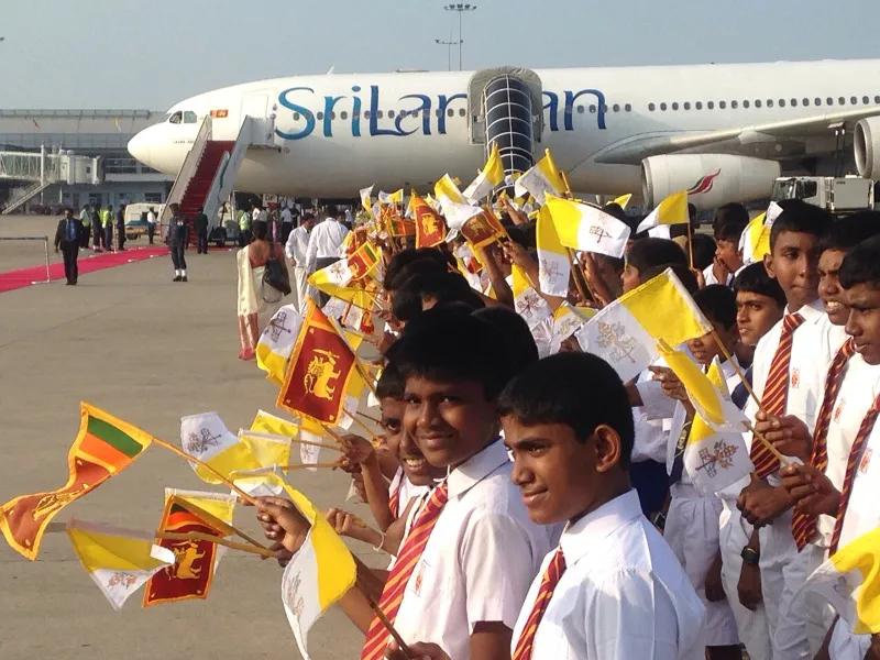 Sri Lankan children line the path to the papal plane at the airport in Colombo Jan. 15. ?w=200&h=150