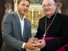 James Rubin, owner of Enviro Waste, presents the relic of St Clement to Archbishop George Stack of Cardiff at the Lady Chapel of Westminster Cathedral, June 19, 2018. 