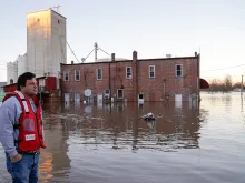 A relief volunteer surveys flood damage in Missouri. 