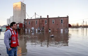 A relief volunteer surveys flood damage in Missouri.   St. Louis Red Cross.
