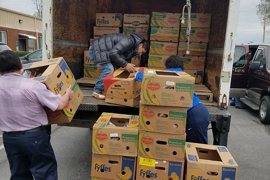 Volunteers unload boxes of donations for immigrant families at St. Patrick Catholic Church in Morristown, Tenn. ?w=200&h=150