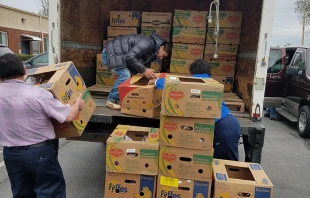 Volunteers unload boxes of donations for immigrant families at St. Patrick Catholic Church in Morristown, Tenn.   Fr. Patrick Brownell.