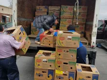 Volunteers unload boxes of donations for immigrant families at St. Patrick Catholic Church in Morristown, Tenn. 