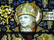St. Patrick, as seen in C.E. Kempe's stained glass in St. John the Baptist parish, Burford, UK. 