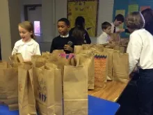 Students at St. Peter's School in Washington, D.C. make breakfast bags for the homeless. 