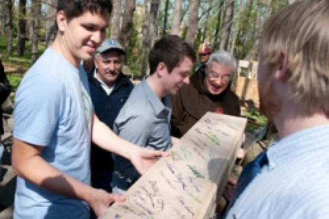 Students from CUA carry a signed beam for the hermitage while Rev Jeremy Harrington OFM looks on Courtesy of Catholic University of America CNA US Catholic News 4 4 12
