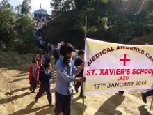Students lead the Medical Awareness Campaign March in Lazu. 