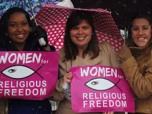 Supporters hold 'Women for Religious Freedom' signs outside of the U.S. Supreme Court building in Washington D.C. on March 25, 2014. 