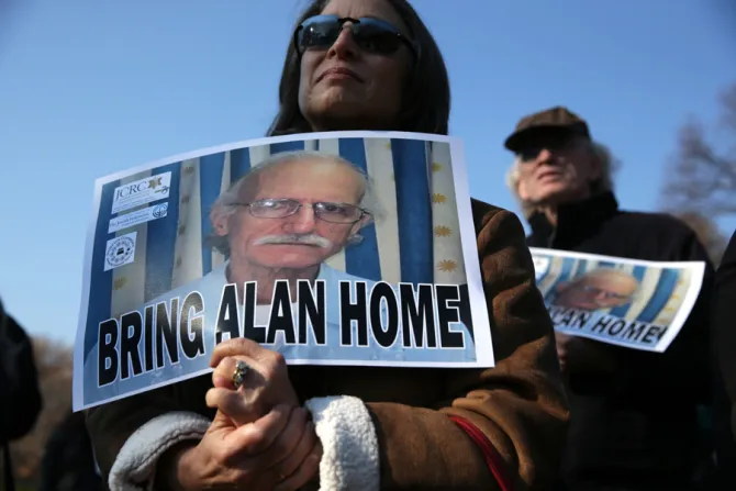 Supporters hold signs Dec 3 2013 in support of imprisoned US citizen Alan Gross He was released from a Cuban prison Dec 17 2014 Credit Alex Wong Getty Images CNA 12 17 14