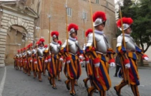 Swiss Guards march through Vatican City.