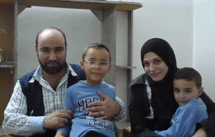 Syrian refugee and Caritas Jordan volunteer Amer Fahd Al Naser, his wife Noor, and their sons, at their apartment in Jordan, October 2014.   Kevin Jones/CNA.