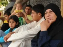 Noujad (far right) lost her husband to the violence in Syria, and her son is still missing. 