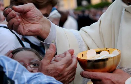 The Eucharist is distributed during Mass with Pope Francis in Rome's Campo Verano cemetery for All Saints Day on Nov. 1, 2013. ?w=200&h=150