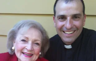 Fr. Andrews poses with Betty White 