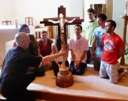 The Olympic Cross being blessed by Fr. Simon, with youth leaders from the Joshua Camp. ?w=200&h=150