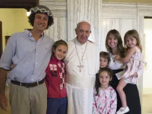 The Walker family from Argentina embraces Pope Francis in Philadelphia, Sept. 27, 2015. 