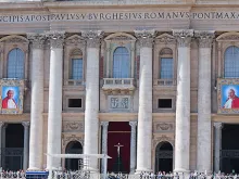 The images of Pope John XXIII and Pope John Paul II hanging from the facade of St. Peter's Basilica at the Vatican April 25, 2014 