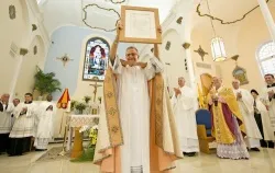 Father John Baker holds up the letter bestowing the designation of Basilica on St. Mary Star of the Sea Catholic Church in Key West, Fla.?w=200&h=150