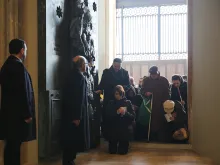 Pilgrims pass through the Holy Doors of the Archbasilica of St. John Lateran in Rome, Dec. 13, 2015. 