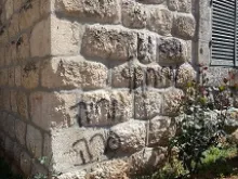 Grafitti sprayed upon the walls of the Marian shrine at Deir Rafat. 