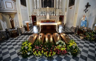This picture taken March 21, 2020 shows coffins on the ground of the church in Serina, near Bergamo, northern Italy.
