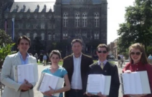 Thomas Peters of Catholic Vote and concerned members of the Georgetown community holds the four binders with more than 35,000 signatures.